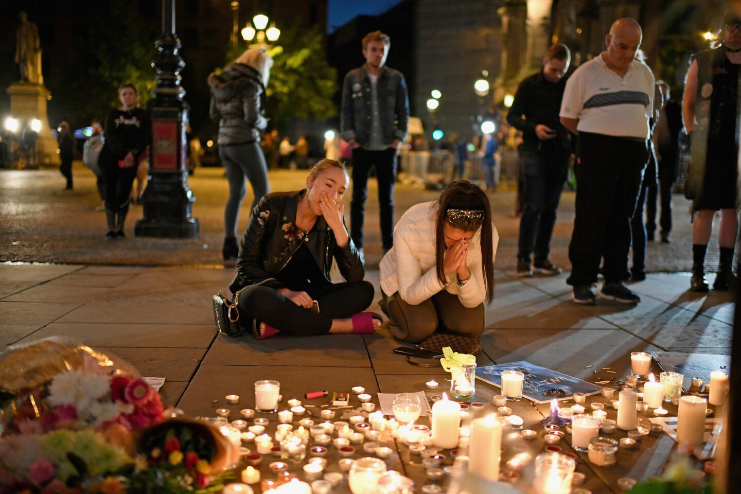 Mourners attend a candlelight vigil on May 23, 2017, to honor the victims of the terrorist attack a day earlier at Manchester Arena in England.