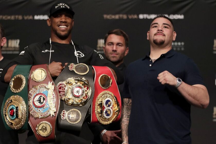 British boxer Anthony Joshua, left, and Andy Ruiz pose for photographers during a press conference ahead of their heavyweight bout, Thursday, May 30, 2019, in New York. Joshua will defend his WBA, WBO and IBF heavyweight titles. (AP Photo/Julio Cortez)
