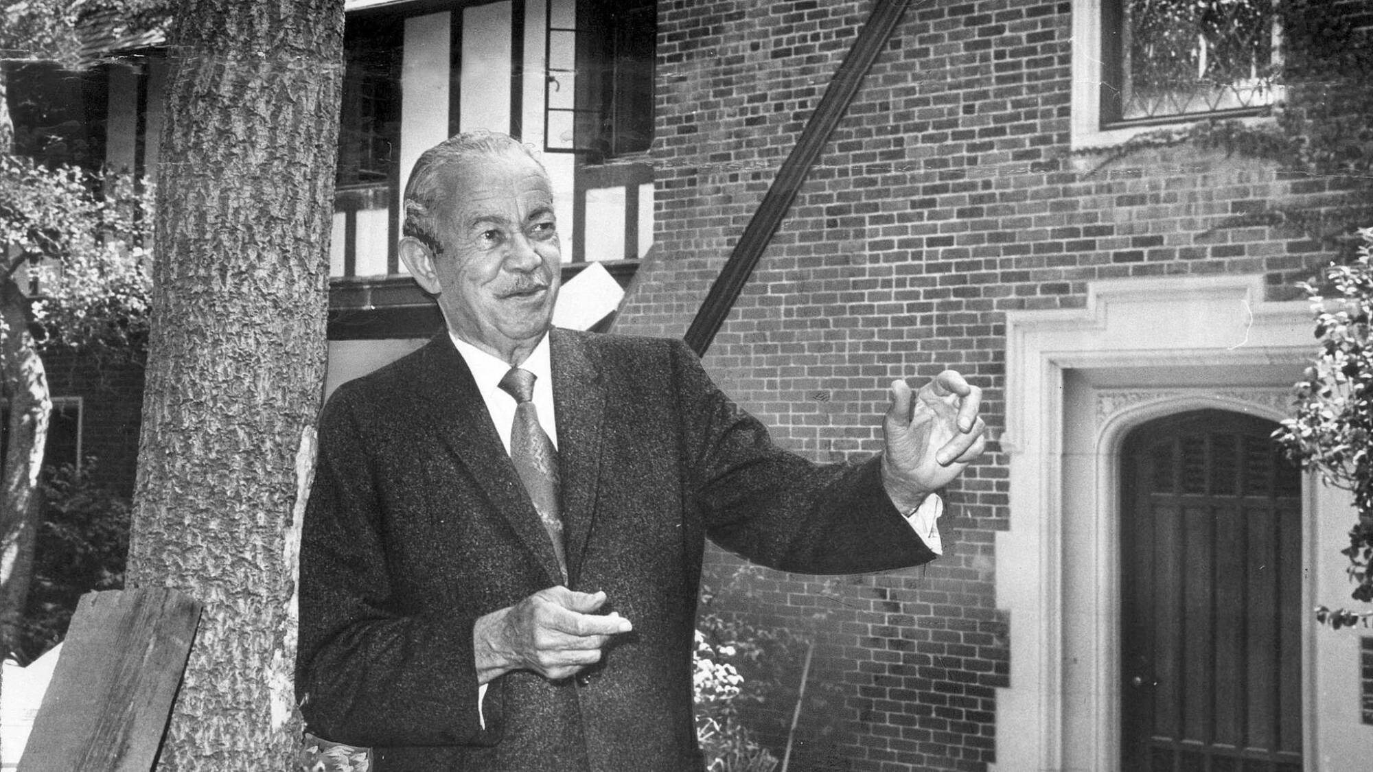Architect Paul Revere Williams in 1970, standing before a Tudor mansion he designed in 1928.