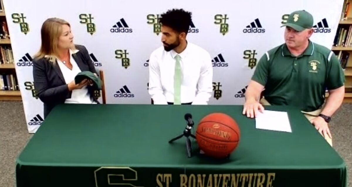 New Ventura St. Bonaventure coach Wolfgang Wood, center, principal Christina Castro and athletic director John Muller.