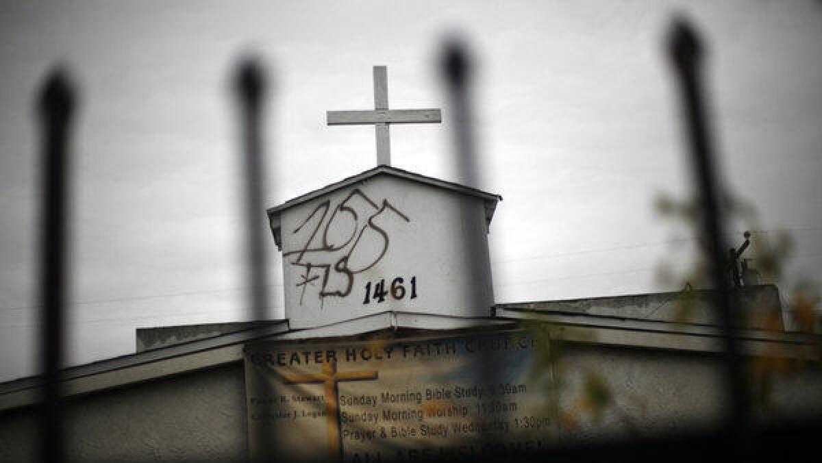 Graffiti mars the steeple on the Greater Holy Faith Missionary Baptist Church in Compton in January. Cases of vandalism make up close to one-third of reported hate crimes, according to a new report.