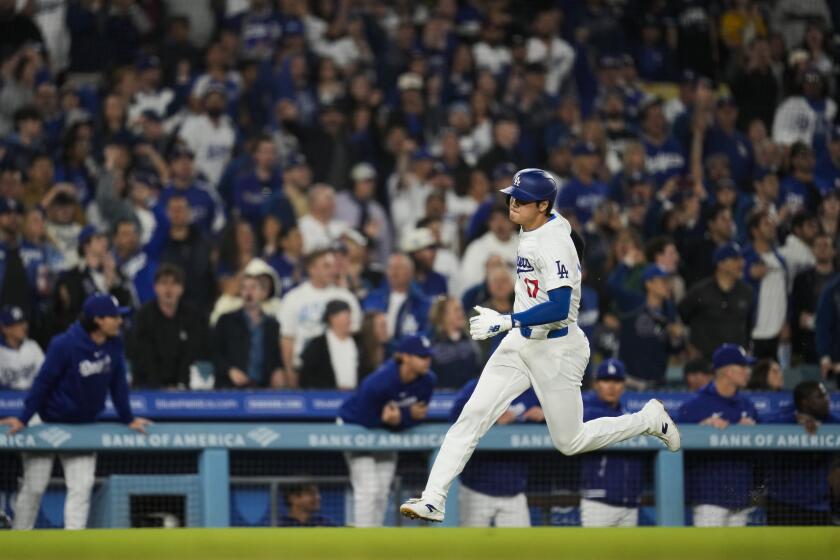 Los Angeles Dodgers designated hitter Shohei Ohtani scores off of a double hit by Will Smith during the third inning of a baseball game against the San Francisco Giants in Los Angeles, Wednesday, April 3, 2024. (AP Photo/Ashley Landis)