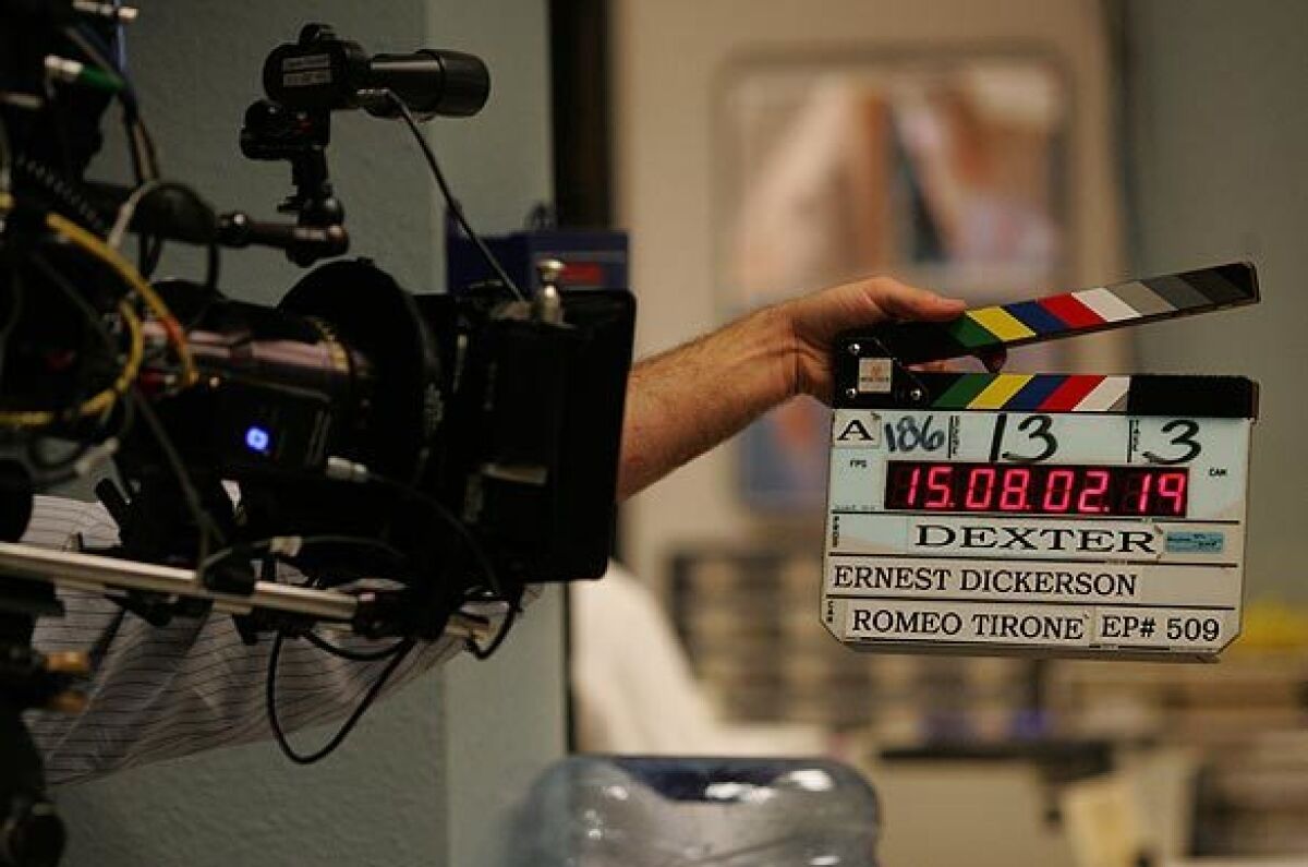 A clapper marks the beginning of a scene during a long-ago taping of "Dexter."