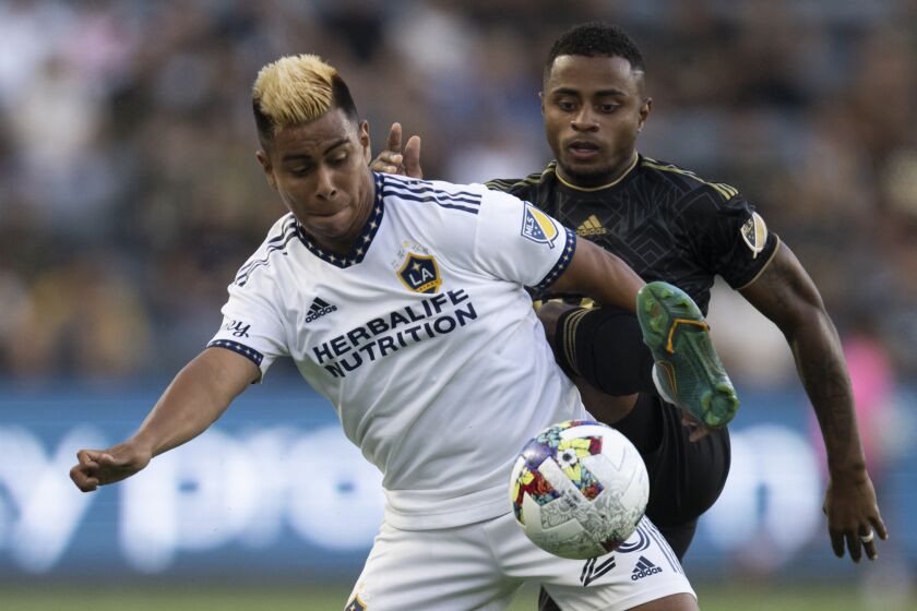 LA Galaxy midfielder Efrain Alvarez, left, and Los Angeles FC defender Diego Palacios.