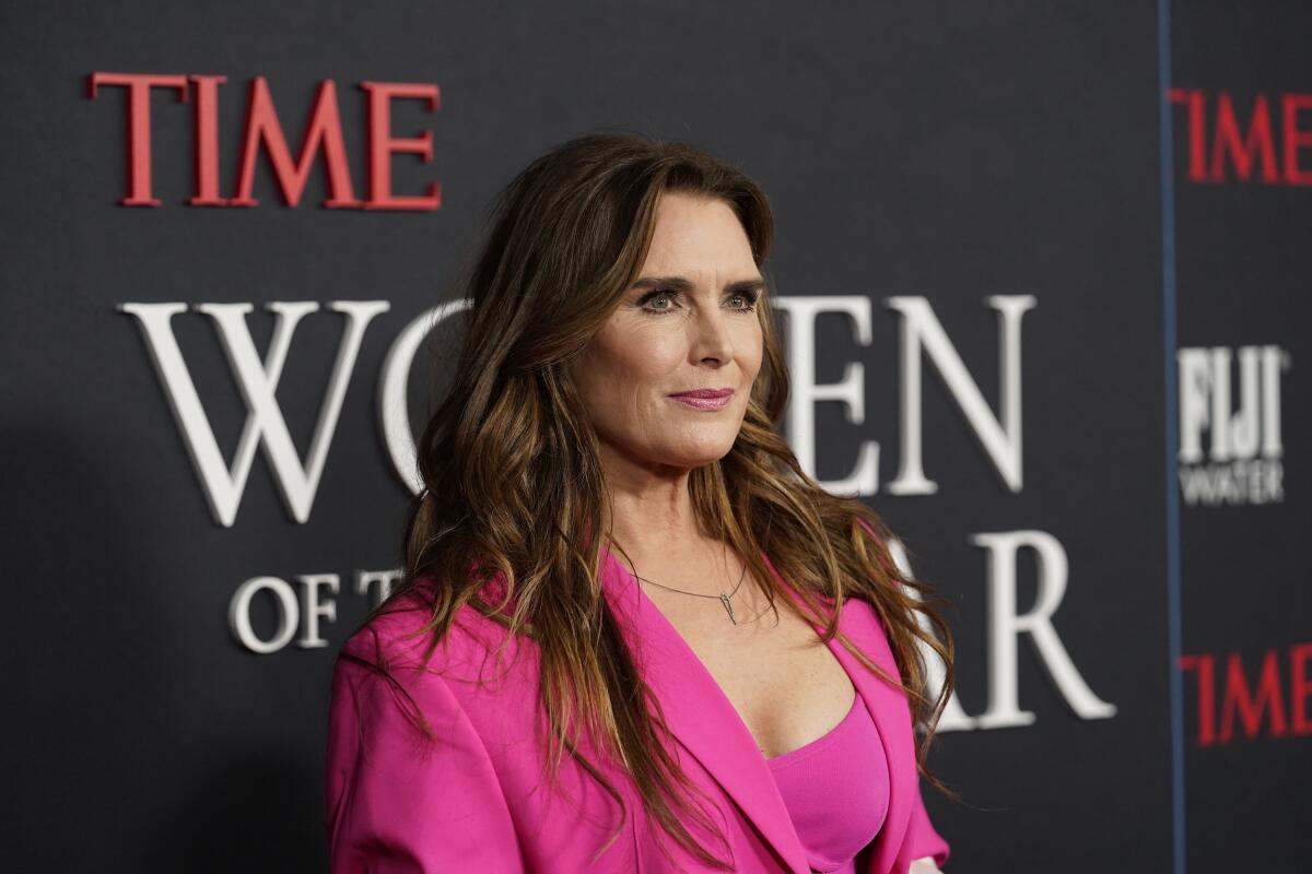 Brooke Shields poses in a pink blazer.