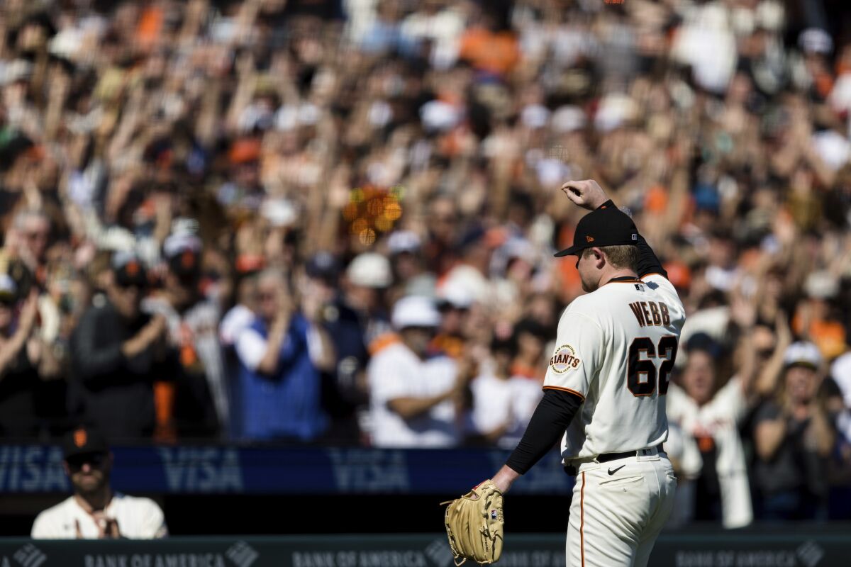 San Francisco Giants starting pitcher Logan Webb acknowledges the fans as he leaves the field in the eighth inning of a baseball game against the San Diego Padres in San Francisco, Sunday, Oct. 3, 2021. (AP Photo/John Hefti)