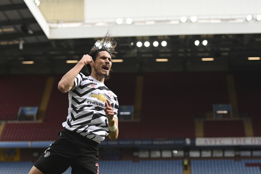 Manchester United's Edinson Cavani celebrates after scoring his side's third goal during the English Premier League soccer match between Aston Villa and Manchester United at Villa Park in Birmingham, England, Sunday, May 9, 2021. (Shaun Botterill/Pool via AP)