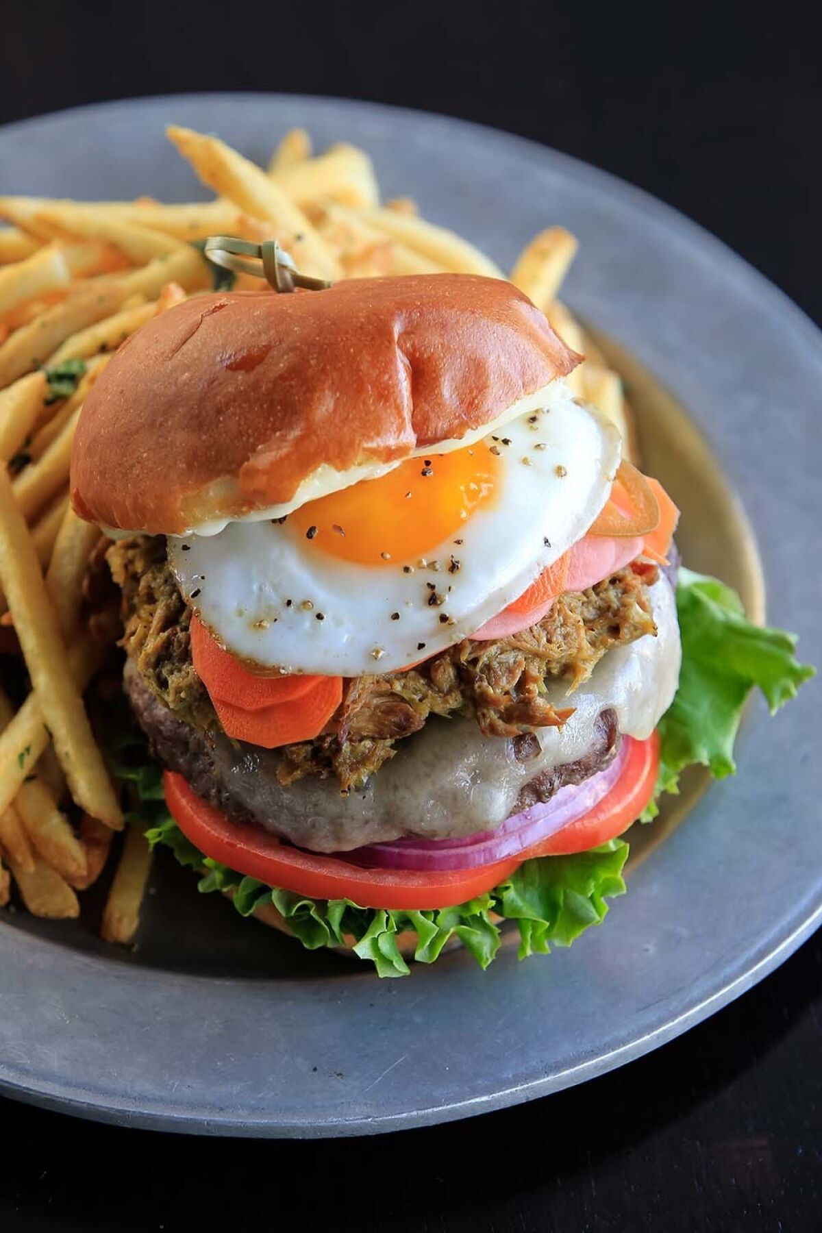 The Waypoint Burger (with aged white cheddar, smoked tomatillo pulled pork, roasted garlic aioli, spicy house pickled veggies, sunny egg).