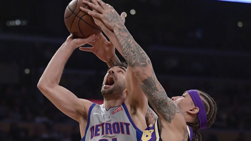 Lakers forward Michael Beasley, right, ties up Detroit Pistons guard Jose Calderon as Calderon tries to shoot during the first half on Wednesday.
