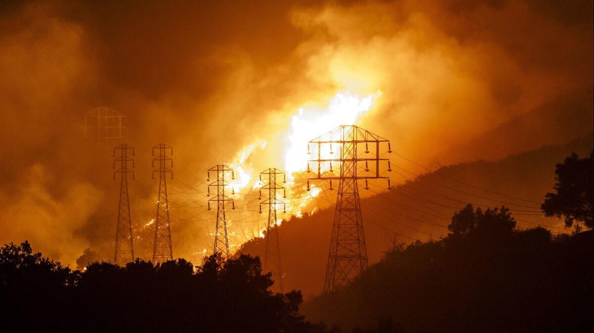 Flames whip around utility power lines near Montecito, Calif., on Dec. 16, 2017, during the Thomas fire.