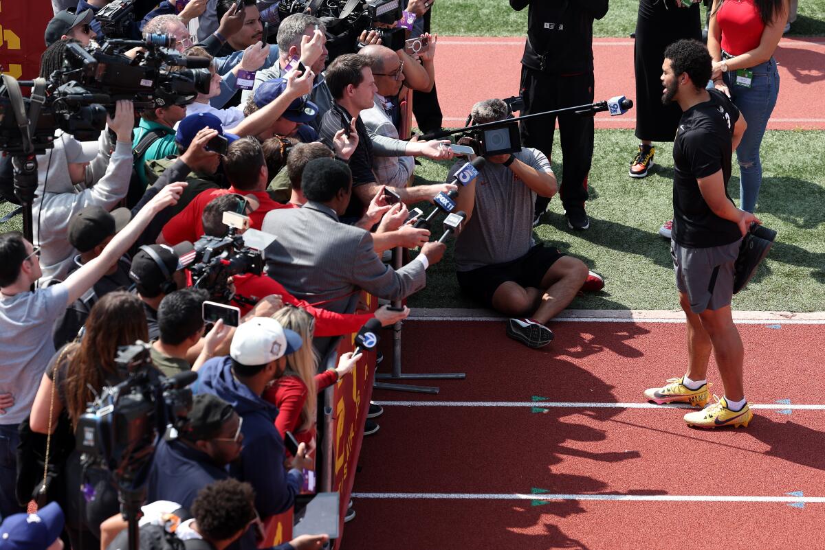 USC quarterback Caleb Williams talks to a throng of media at USC pro day Wednesday. 
