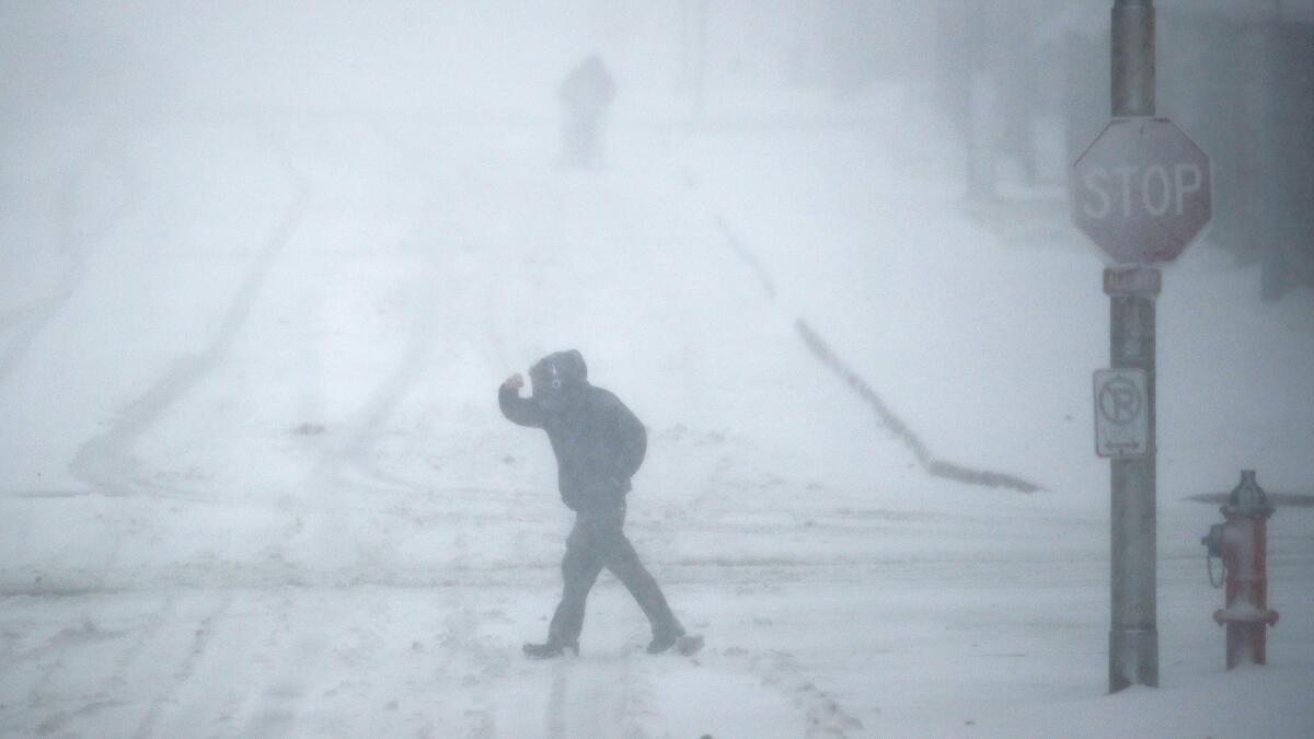 Snow falls Sunday in Kansas City, Mo. Blizzard-like conditions have closed highways and delayed air travel as a winter storm moves through the Midwest.