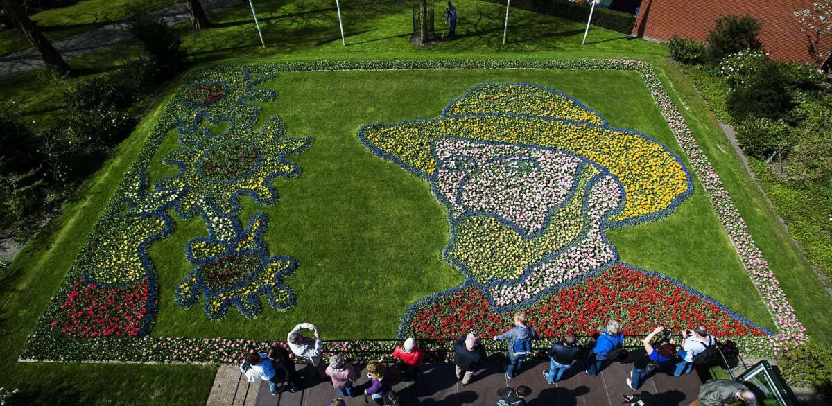 People look at Tulips planted to form a portrait of Dutch painter Vincent van Gogh at Keukenhof flower garden in Lisse on April 21, 2015.