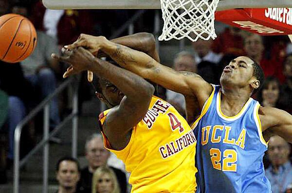 UCLA center J'mison Morgan knocks the ball from the grasp of USC forward Leonard Washington in the first half Sunday night.
