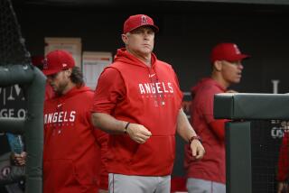 Los Angeles Angels manager Phil Nevin looks on during a baseball game.