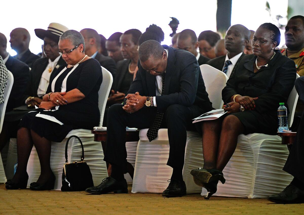 Kenyan President Uhuru Kenyatta prays during a funeral service for his nephew Mbugua Mwangi and his fiancee, Rosemary Wahito, in Nairobi on Friday. Both died in the Westgate Mall terrorist attack.