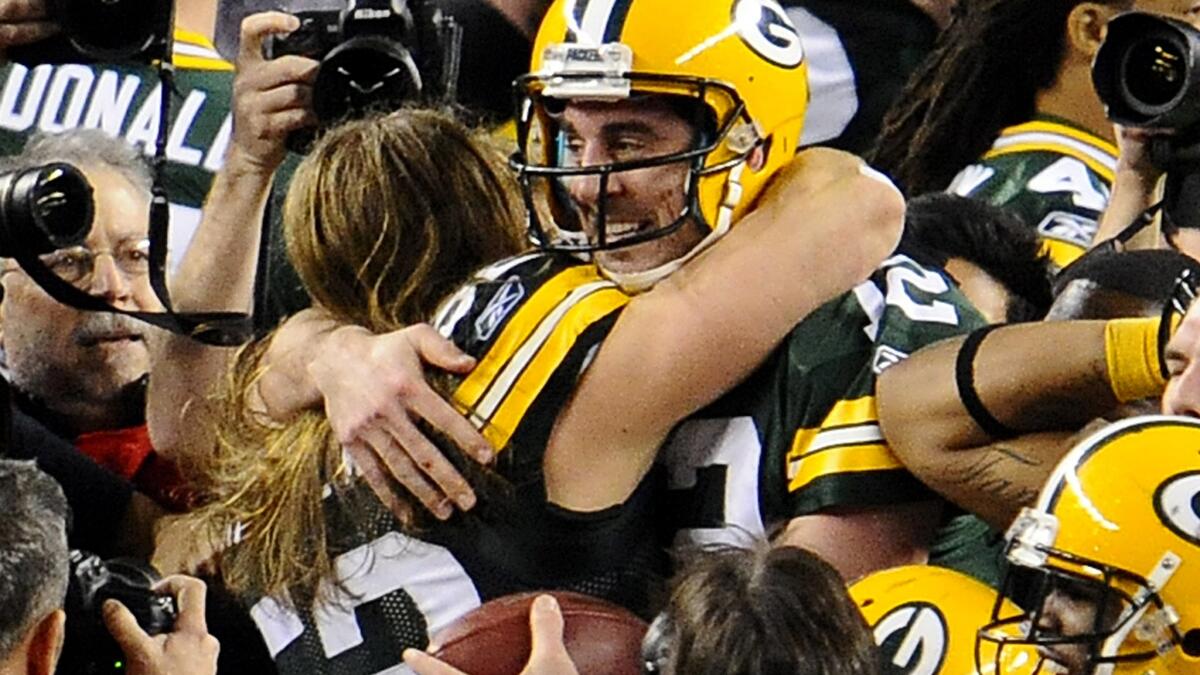 Packers quarterback Aaron Rodgers (12) and teammate Clay Matthews celebrate after winning Super Bowl XLV.