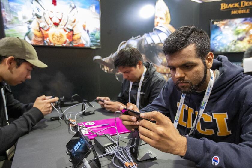 Hamzah Hameed, right, plays Black Desert Online during the Inven Global Esports Deep Dive conference at UCI on Tuesday, May 1.