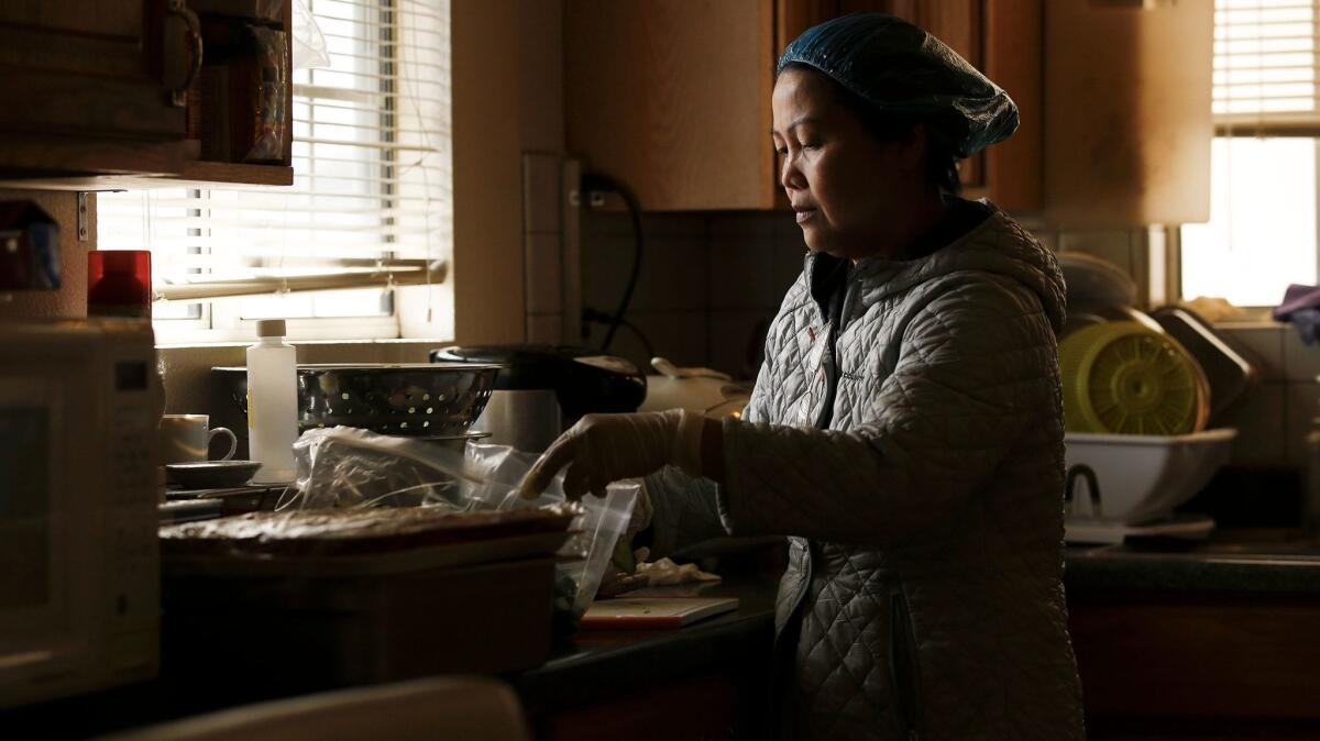 Hue Phan is one of many cooks in Little Saigon who work long hours in their homes to provide a type of service known as "com thang," literally translated as "monthly rice." (Mark Boster / Los Angeles Times)