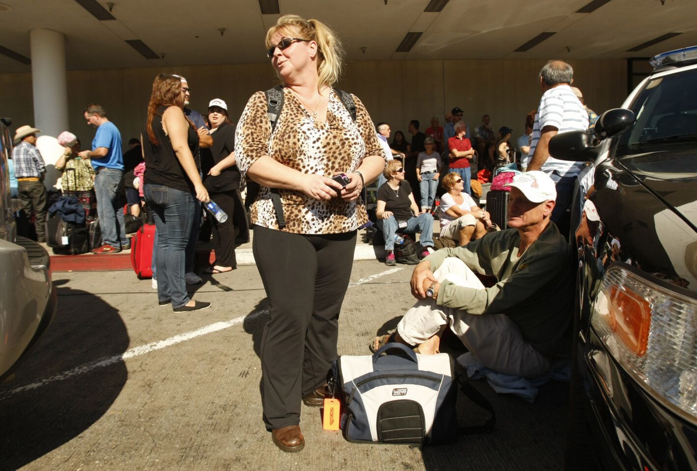Passengers wait outside Terminal 1 at LAX.