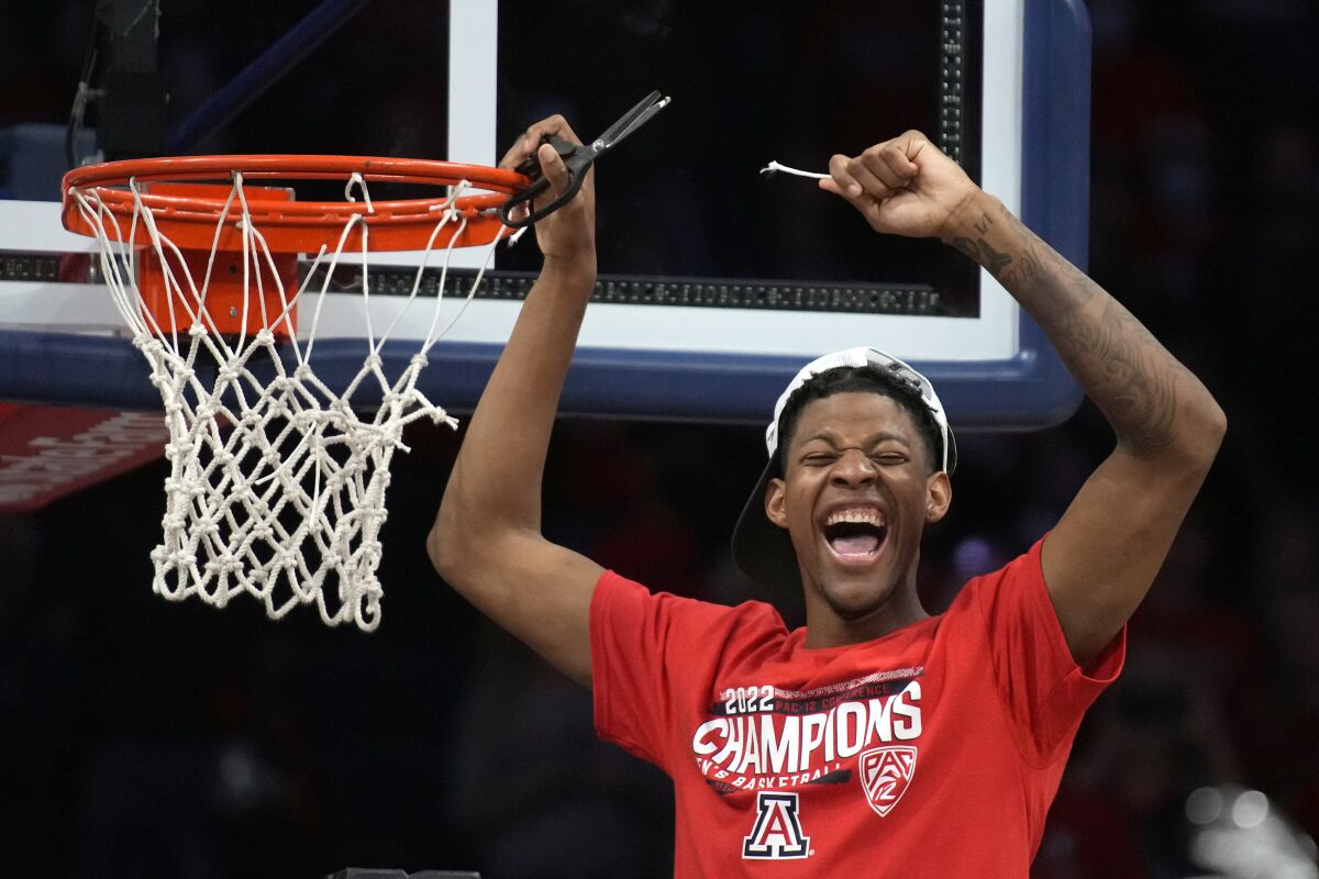 Arizona guard Dalen Terry (4) celebrates while cutting the net after an NCAA college basketball game against California, Saturday, March 5, 2022, in Tucson, Ariz. Arizona won the Pac-12 Conference Championship. (AP Photo/Rick Scuteri)