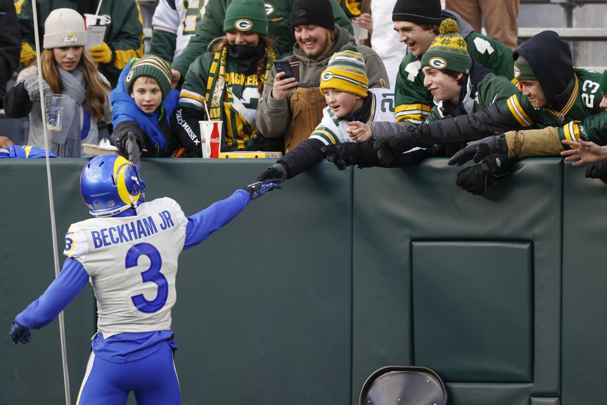 Rams receiver Odell Beckham Jr. shakes hands with a fan before the game.