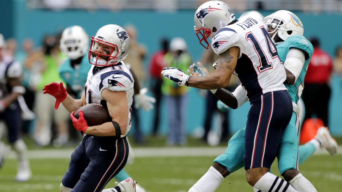 Patriots receiver Michael Floyd (14) delivers a key block downfield to spring teammate Julian Edelman on a 77-yard touchdown pass play during the third quarter Sunday.