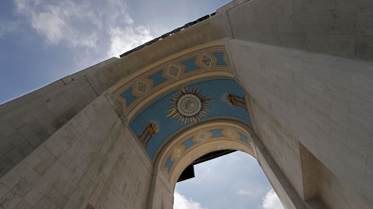 A mural beneath the peristyle at the Los Angeles Memorial Coliseum was recently restored with its vibrant blue and gold-leaf paint.