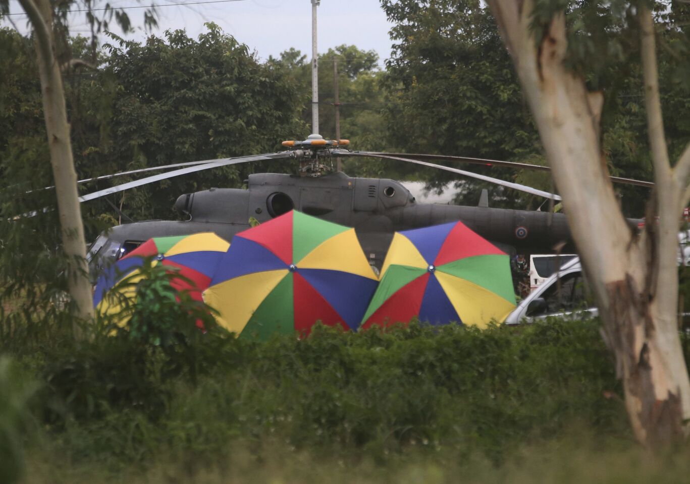 Police place umbrellas around an evacuation helicopter after the last of the trapped boys and their coach were extracted from a cave in Mae Sai, Thailand on July 10.