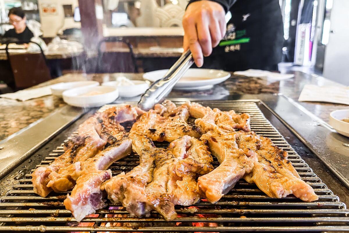 Marinated baby back ribs on a grill at Soot Bull Jeep in Koreatown.