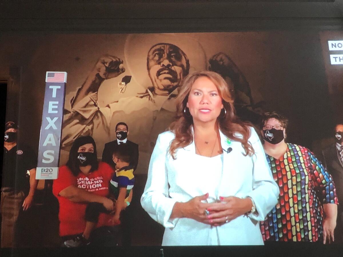 The Texas delegation to the Democratic National Convention stands before a mural.