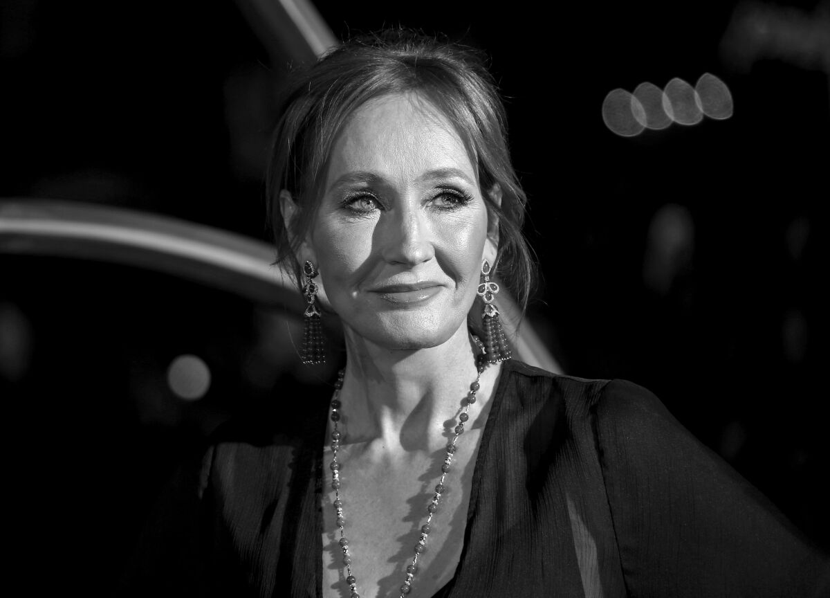 Black-and-white, head-and-shoulders portrait of J.K. Rowling slightly smiling and looking forward to her left. 