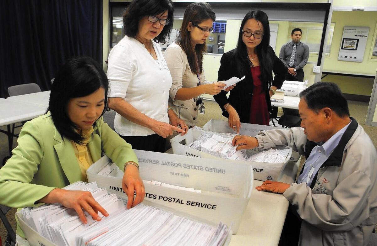 Orange County election officials and observers review ballot envelopes and other materials used in a special election for a Board of Supervisors seat on Feb. 10, 2015, at the Registrar of Voters office in Santa Ana. Former state Sen. Lou Correa requested the review after stopping a recount that resulted in no changes in the totals in the race, which Andrew Do won by 43 votes.