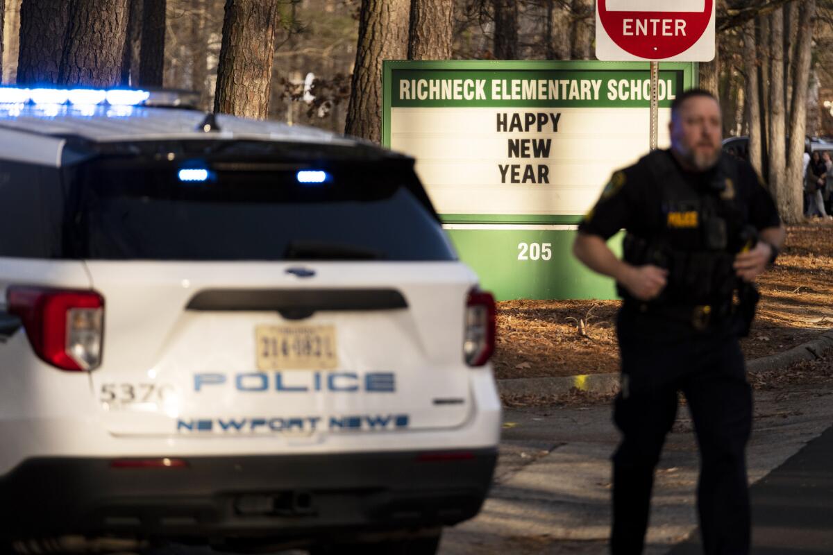 A police officer and car outside an elementary school