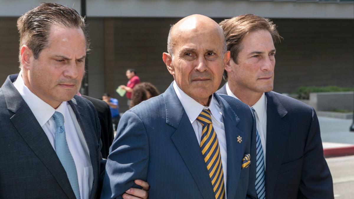 Former Los Angeles County Sheriff Lee Baca, center, outside federal court in Los Angeles on May, 12 after he was sentenced to three years in prison.
