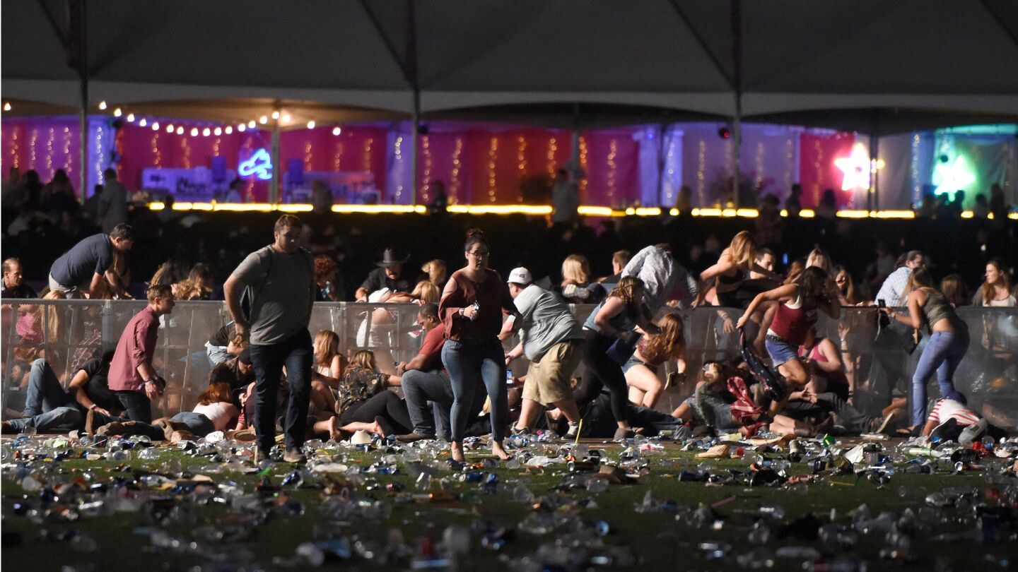 People run and take cover at the Route 91 Harvest country music festival after hearing gunfire.