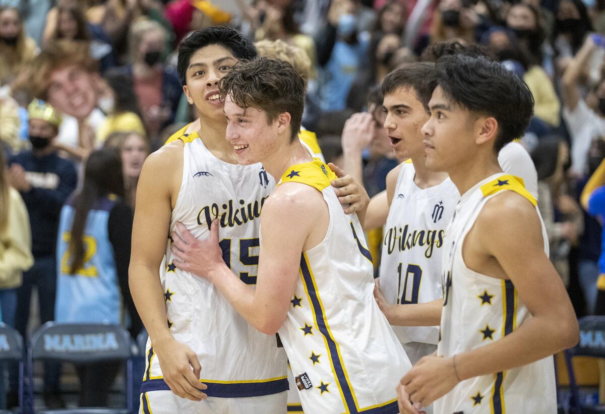 Marina's Kenji Duremdes, left, celebrates with Dylan Gomez after beating Huntington Beach in Friday's Wave League game.