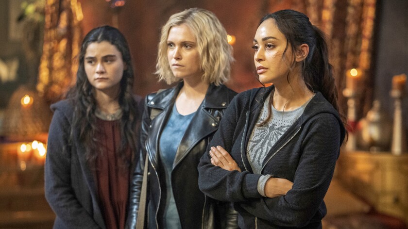 Lola Flanery, left, Eliza Taylor and Lindsey Morgan in a new episode of "The 100" on The CW.