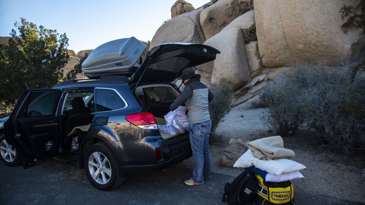 Natalie Elsman of Iowa loads her car to move from her campground at Jumbo Rocks as all the campgrounds at Joshua Tree National Park closed at noon on Jan. 2.