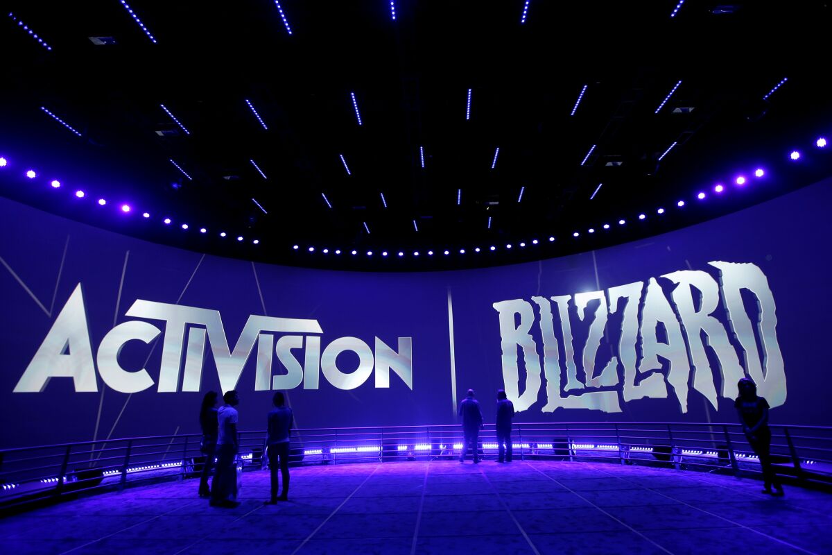 The Activision Blizzard booth with purple lighting and Activision and Blizzard in big letters on a wall