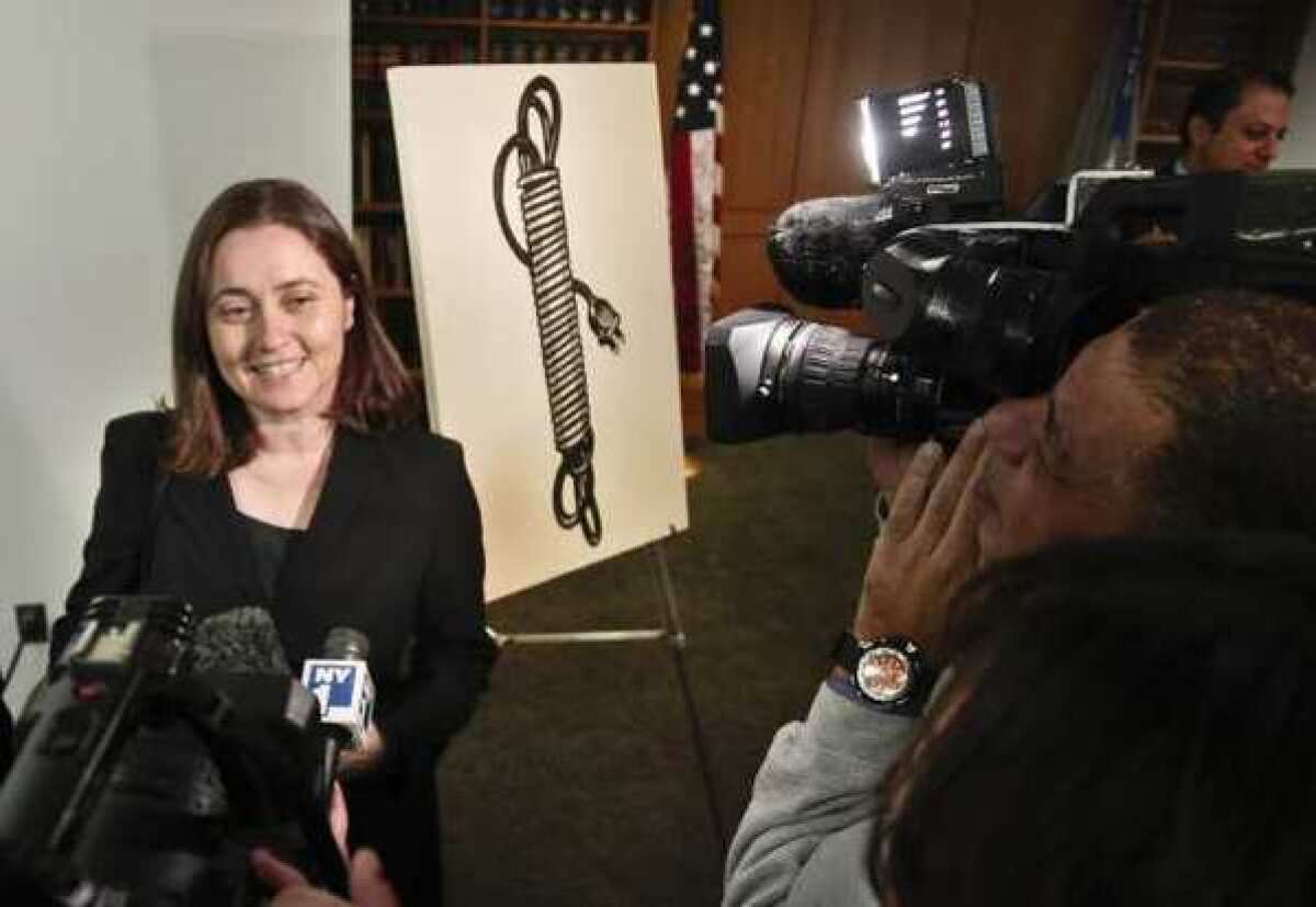 Barbara Bertozzi, the widow of art dealer Leo Castelli, stands next to the Roy Lichtenstein painting "Electric Cord" at a news conference.