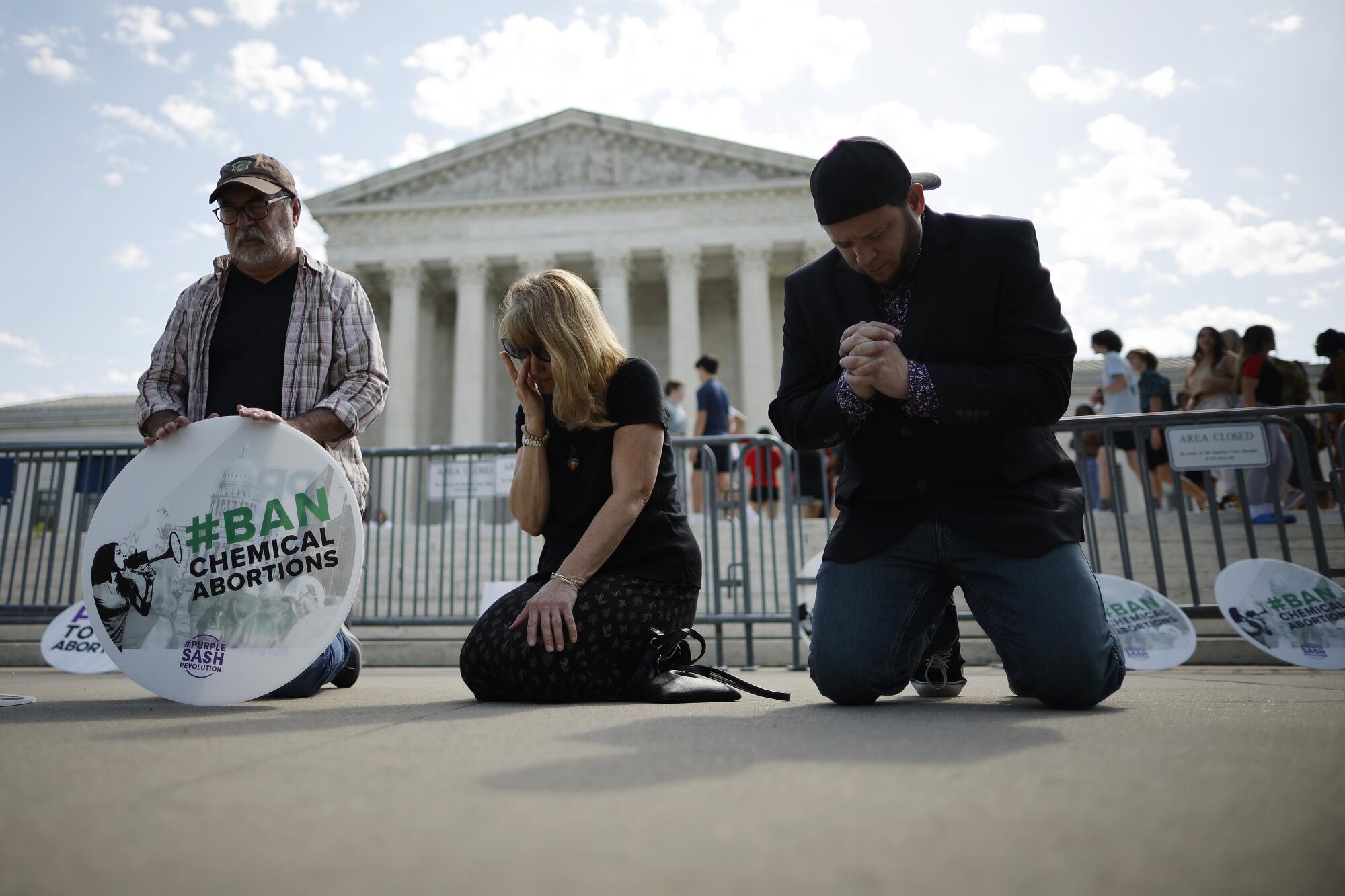Antiabortion activists pray outside the U.S. Supreme Court.