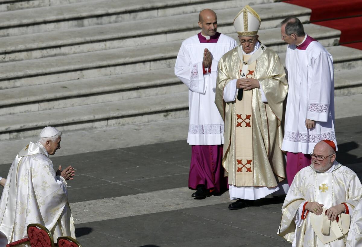 Pope Emeritus Benedict XVI, left, waits for Pope Francis, second from right, at the beatification of Pope Paul VI and a Mass for the closing of a two-week synod on family issues.