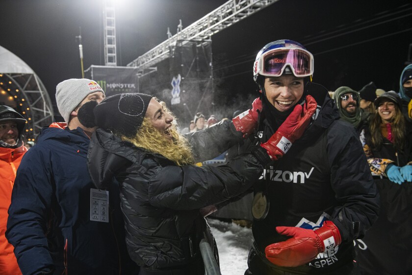 Scotty James celebrates with his fiancé Chloe Stroll after winning a gold medal in men's snowboard superpipe at the 2022 Winter X Games in Aspen on Friday, Jan. 21, 2022. (Kelsey Brunner/The Aspen Times via AP)