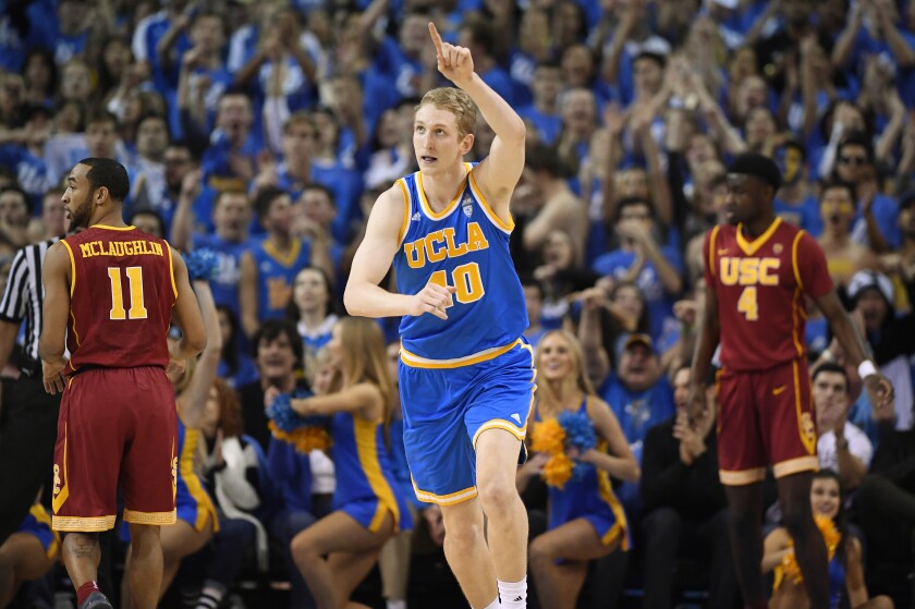 UCLA center Thomas Welsh, center, gestures after scoring against USC in 2017.