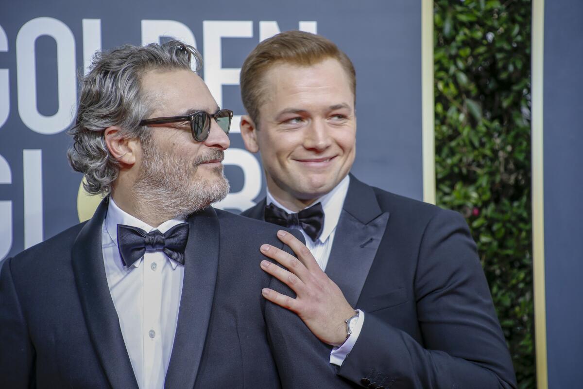 Joaquin Phoenix, left, and Taron Egerton at the Golden Globes 2020