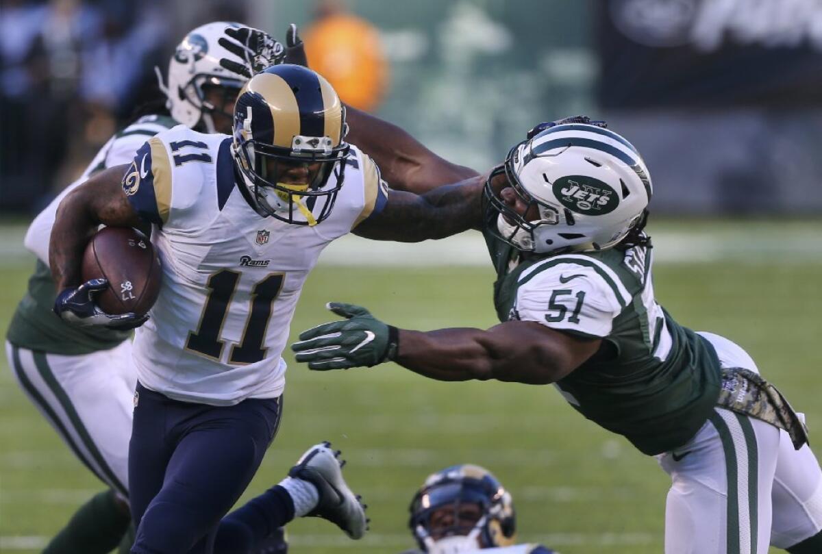 Rams receiver Tavon Austin fends off Jets linebacker Julian Stanford during a game on Nov. 13, 2016.