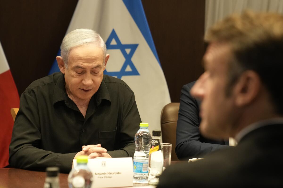 Benjamin Netanyahu facing Emmanuel Macron