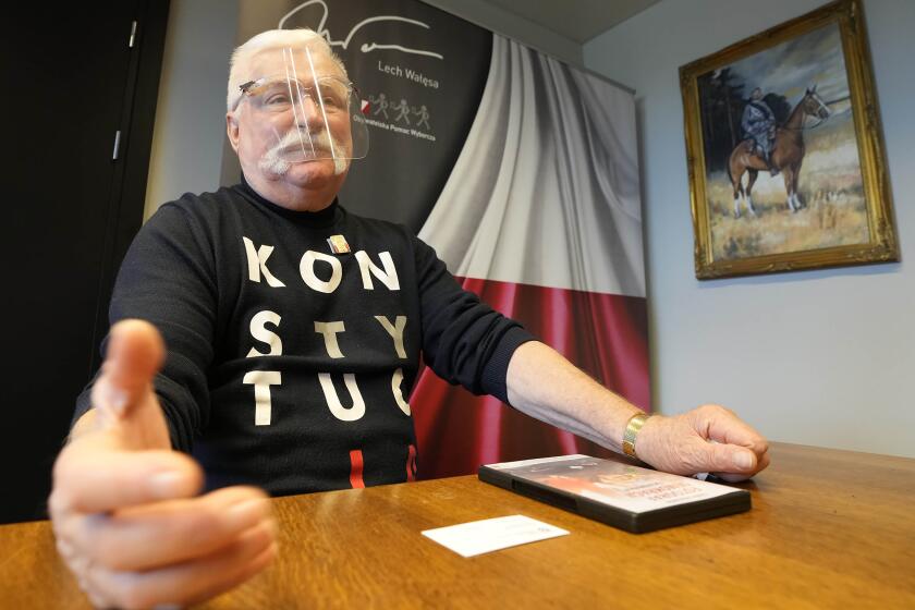 FILE - Poland's former president Lech Walesa wears a T-shirt reminding Poland's current right-wing government that it should respect the nation's constitution, in his office in Gdansk, Poland, on Aug. 26, 2021. Walesa, who is turning 80 Friday, Sept. 29, 2023, is very critical of the conservative government of the Law and Justice party and says Oct. 15 parliamentary elections must bring a change. (AP Photo/Czarek Sokolowski)