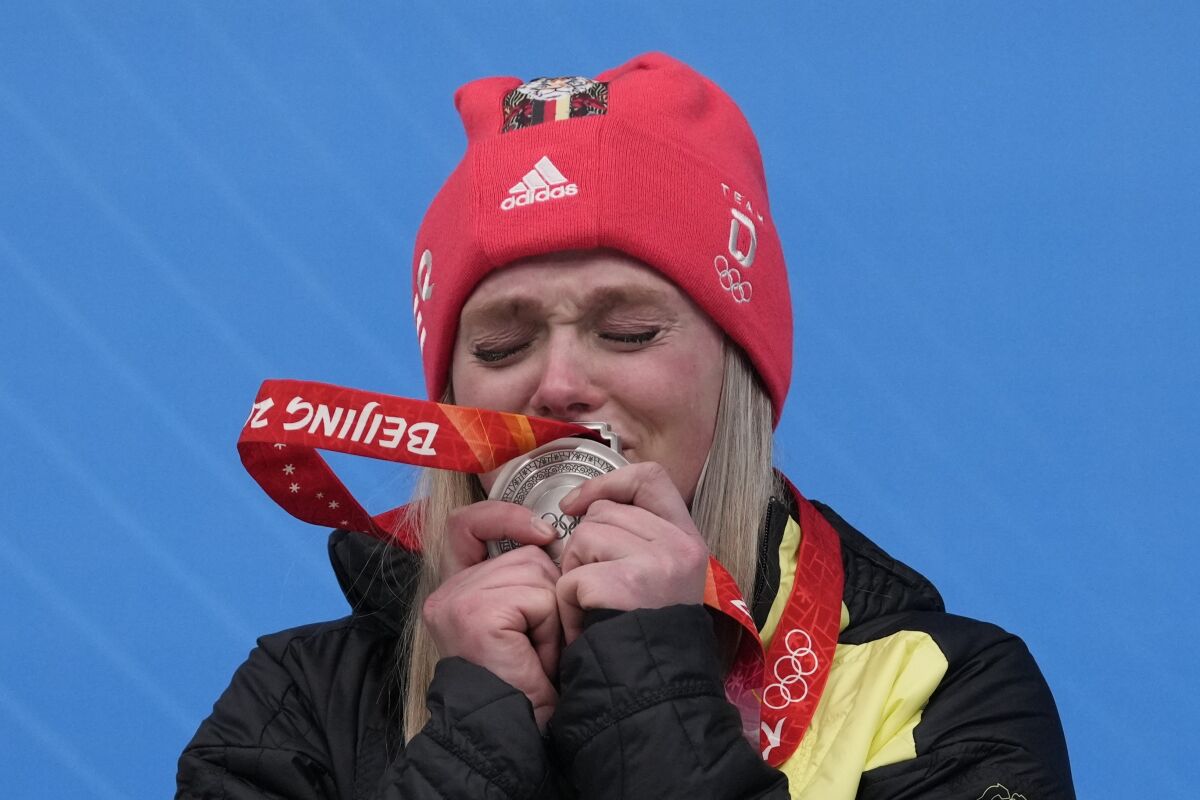 CORRECTS NAME TO ANNA BERRETIER INSTEAD NATALIE GEISENBERG - Anna Berretier, of Germany, kisses the silver medal at the podium of the luge women's singles at the 2022 Winter Olympics, Tuesday, Feb. 8, 2022, in the Yanqing district of Beijing. (AP Photo/Mark Schiefelbein)